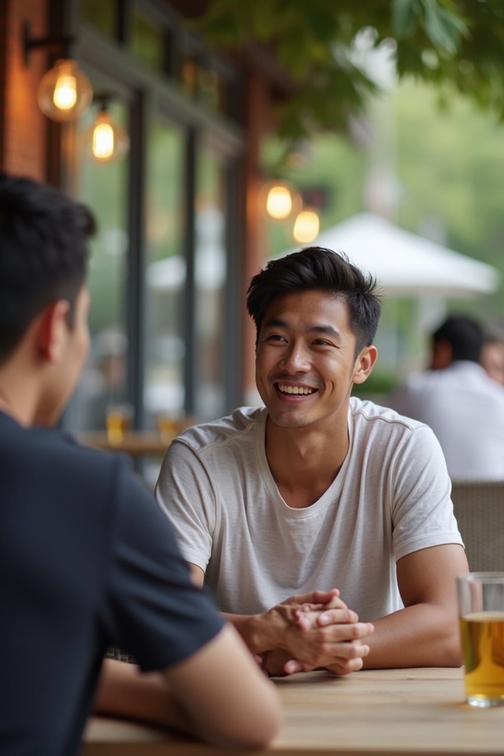 laid-back masculine  man chatting with a friend at a casual outdoor table
