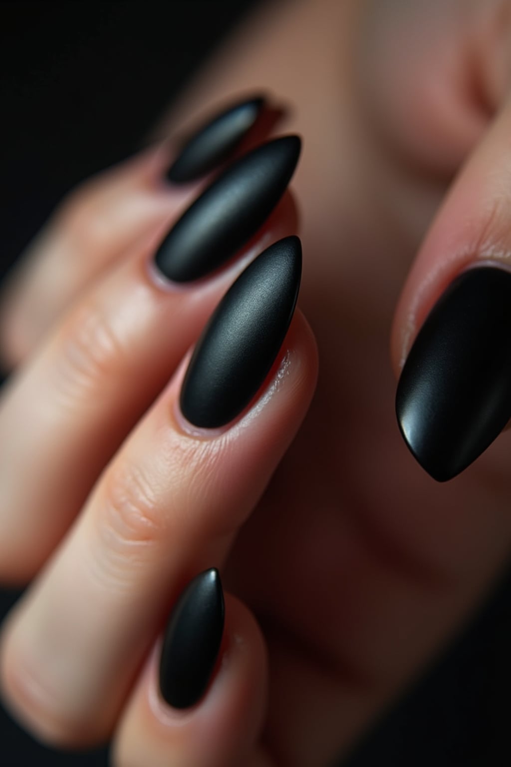 black matte nails with glossy tips, dramatic close-up with contrast lighting, edgy modern styling, professional manicure display