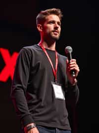 tech conference speaker man holding microphone with lanyard around his neck