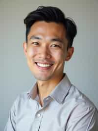 A professional therapist headshot of a compassionate man, taken in a well-lit studio with a plain backdrop. The man is dressed in  a neat, light-colored shirt with a friendly expression. The lighting is soft and even, highlighting their facial features with a warm and approachable expression. The focus is sharp, capturing the man's eyes and reassuring smile, creating a perfect headshot for therapy practices and professional profiles.