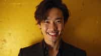 man with evil grin and mischievous look, gold background