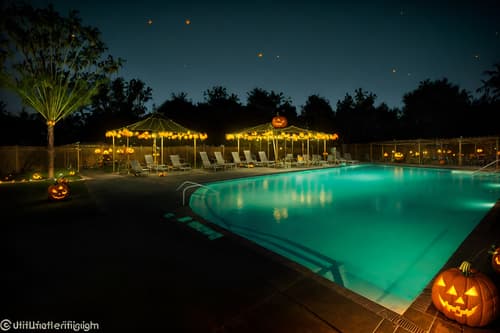 photo from pinterest of halloween-style designed (outdoor pool area ) with pool and pool lights and pool lounge chairs and pool. . with spiderwebs and glowing pumpkins and cobwebs and yellow black balloons and skeletons sitting and standing and human skulls and cobwebs and lanterns. . cinematic photo, highly detailed, cinematic lighting, ultra-detailed, ultrarealistic, photorealism, 8k. trending on pinterest. halloween design style. masterpiece, cinematic light, ultrarealistic+, photorealistic+, 8k, raw photo, realistic, sharp focus on eyes, (symmetrical eyes), (intact eyes), hyperrealistic, highest quality, best quality, , highly detailed, masterpiece, best quality, extremely detailed 8k wallpaper, masterpiece, best quality, ultra-detailed, best shadow, detailed background, detailed face, detailed eyes, high contrast, best illumination, detailed face, dulux, caustic, dynamic angle, detailed glow. dramatic lighting. highly detailed, insanely detailed hair, symmetrical, intricate details, professionally retouched, 8k high definition. strong bokeh. award winning photo.