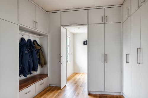 photo from pinterest of minimalist-style interior designed (mudroom interior) with storage drawers and high up storage and cubbies and storage baskets and cabinets and wall hooks for coats and shelves for shoes and a bench. . with focus on the shape, colour and texture of just a few of essential elements and functional furniture and an open floor plan and clean lines and a monochromatic palette with colour used as an accent and lots of light and focus on the shape, colour and texture of just a few of essential elements. . cinematic photo, highly detailed, cinematic lighting, ultra-detailed, ultrarealistic, photorealism, 8k. trending on pinterest. minimalist interior design style. masterpiece, cinematic light, ultrarealistic+, photorealistic+, 8k, raw photo, realistic, sharp focus on eyes, (symmetrical eyes), (intact eyes), hyperrealistic, highest quality, best quality, , highly detailed, masterpiece, best quality, extremely detailed 8k wallpaper, masterpiece, best quality, ultra-detailed, best shadow, detailed background, detailed face, detailed eyes, high contrast, best illumination, detailed face, dulux, caustic, dynamic angle, detailed glow. dramatic lighting. highly detailed, insanely detailed hair, symmetrical, intricate details, professionally retouched, 8k high definition. strong bokeh. award winning photo.
